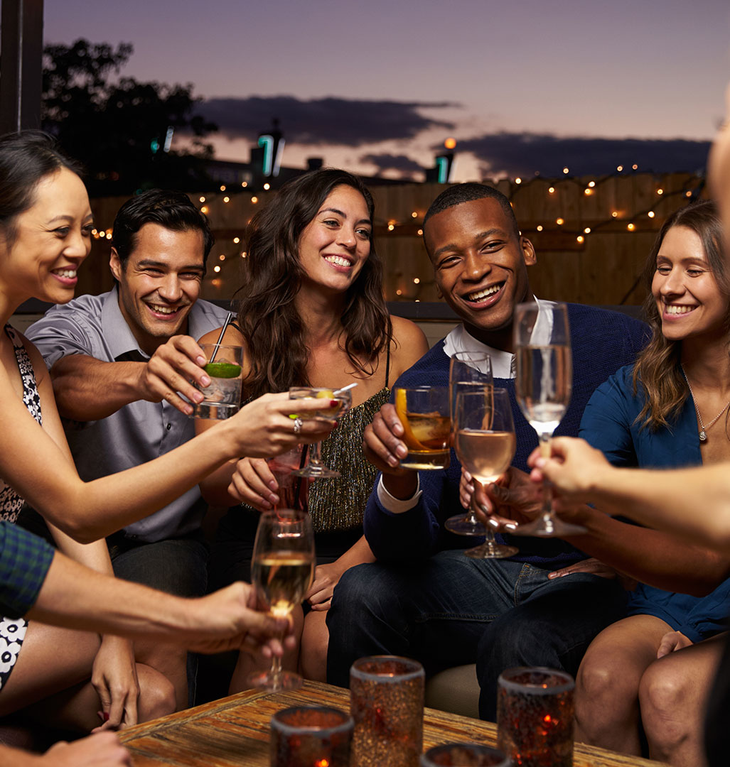 Group of friends having drinks on rooftop